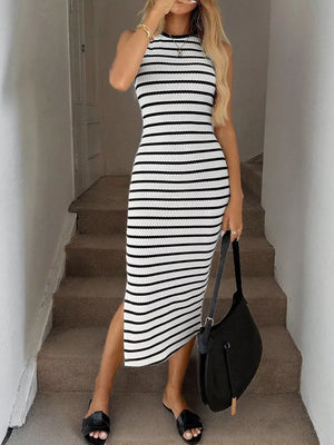 Sleek black and white striped bodycon midi dress with a high neckline and side slit.