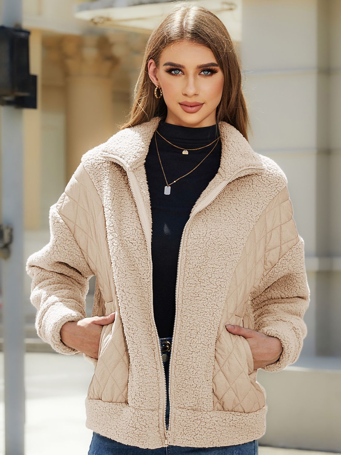 Camel quilted jacket with sherpa panels and zip front, styled with a black turtleneck.
