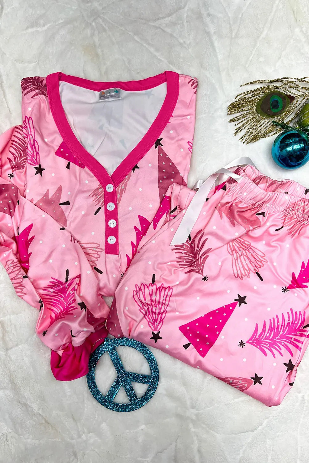 Pink festive print henley pajama set with button front and drawstring pants.