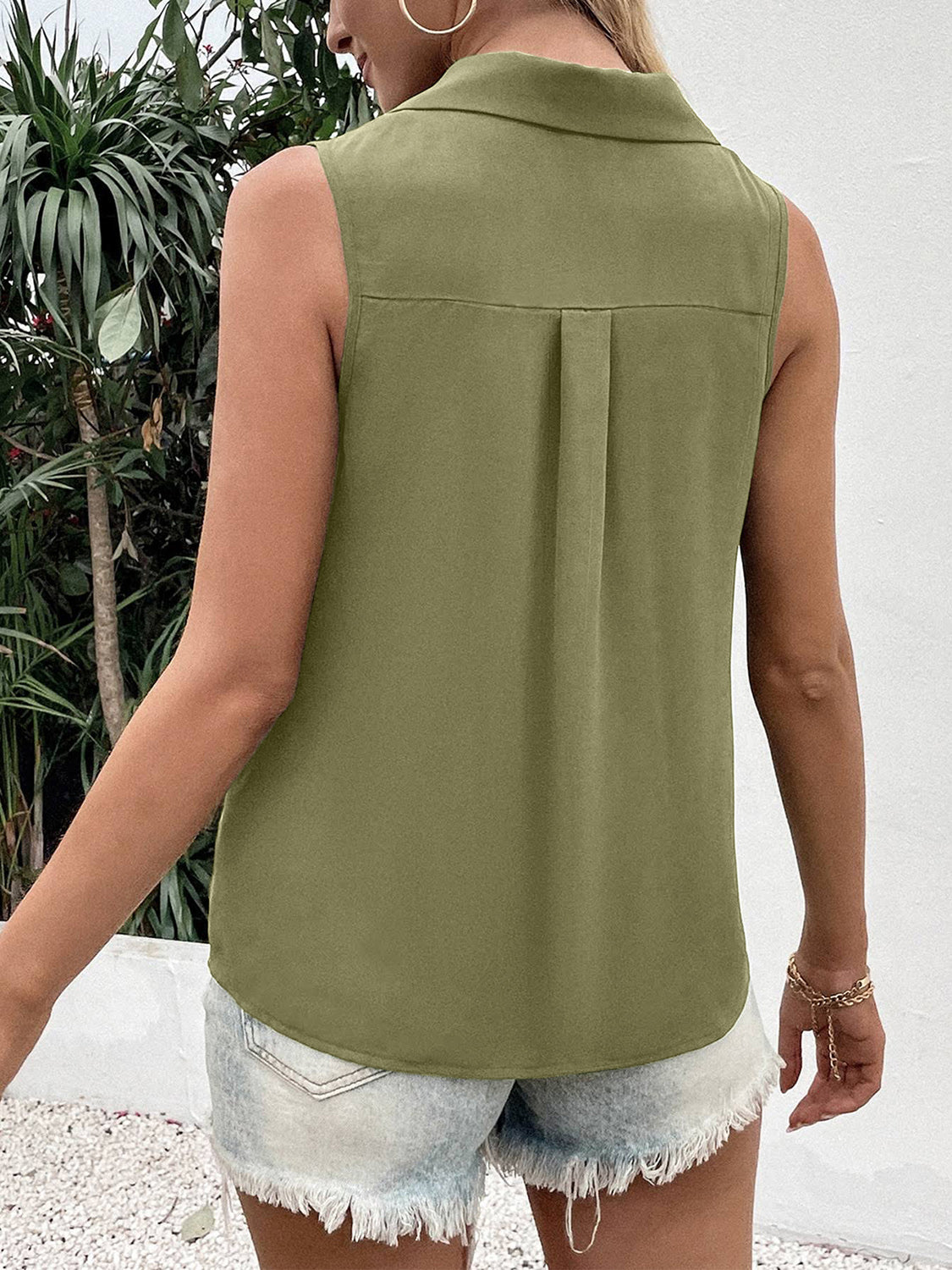 Sleeveless collared button-down blouse in olive green with a back pleat detail.