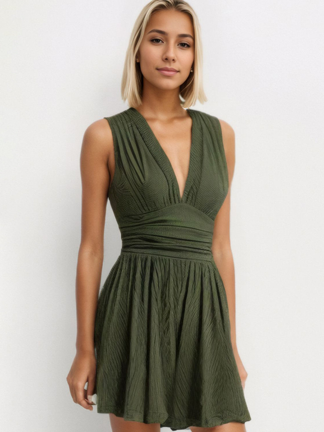 Textured ribbed plunge romper in army green with a cinched waist and flared skirt.