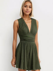Textured ribbed plunge romper in army green with a cinched waist and flared skirt.