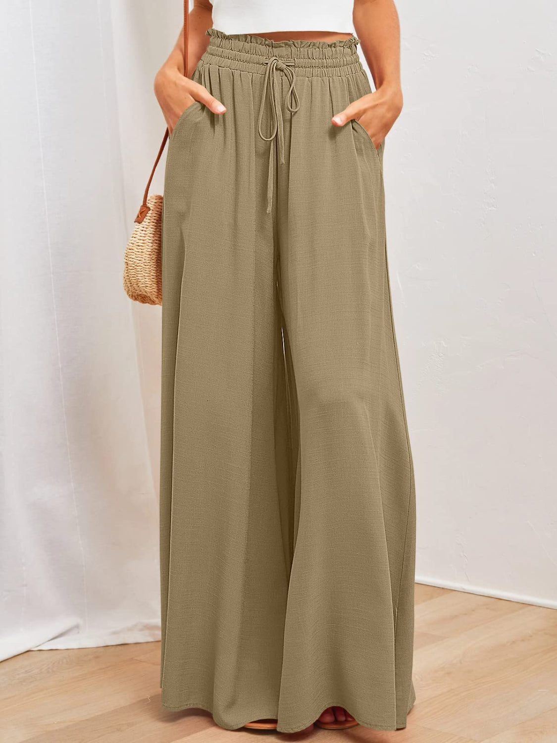 Textured olive brown drawstring palazzo trousers with pockets and wide legs.