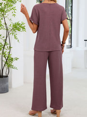 Plum purple waffle knit two-piece set with short sleeve top and wide leg pants.