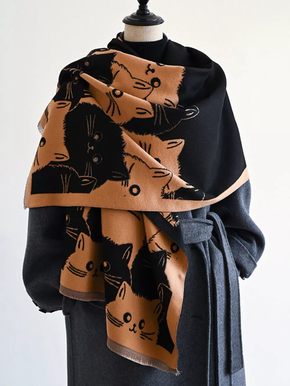 Reversible scarf with black and tan cat pattern, fringed edges.