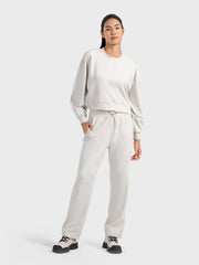 Ivory cropped crewneck sweatshirt with gathered sleeves and drawstring waist.