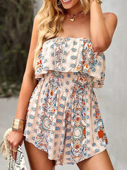 Boho romper with smocked waist and ruffled strapless neckline in a beige paisley print.