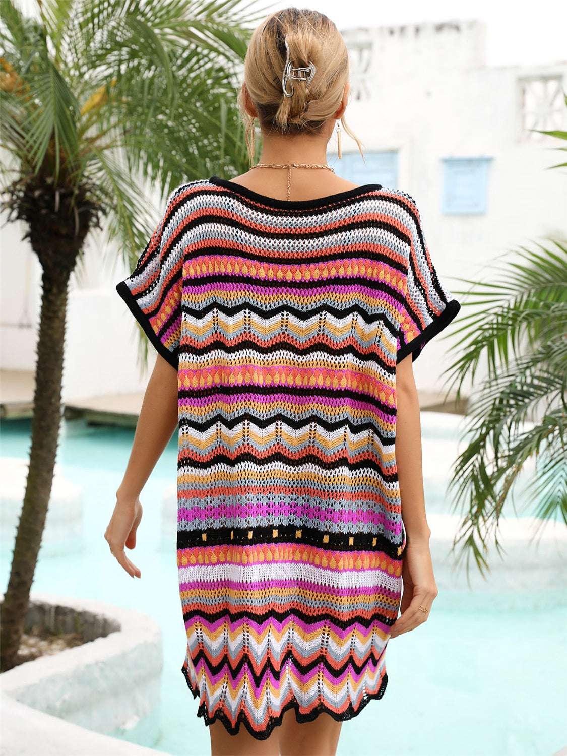 Chevron knit beach cover-up with multicolor stripes and black trim.