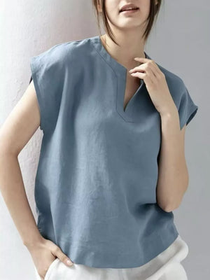 Blue cap sleeve shirt with notched neckline and relaxed fit.