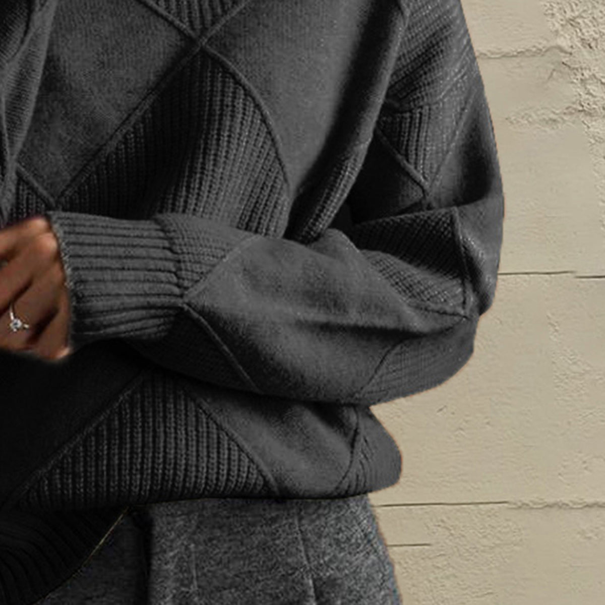 Black diamond knit turtleneck pullover with ribbed cuffs and textured panels.