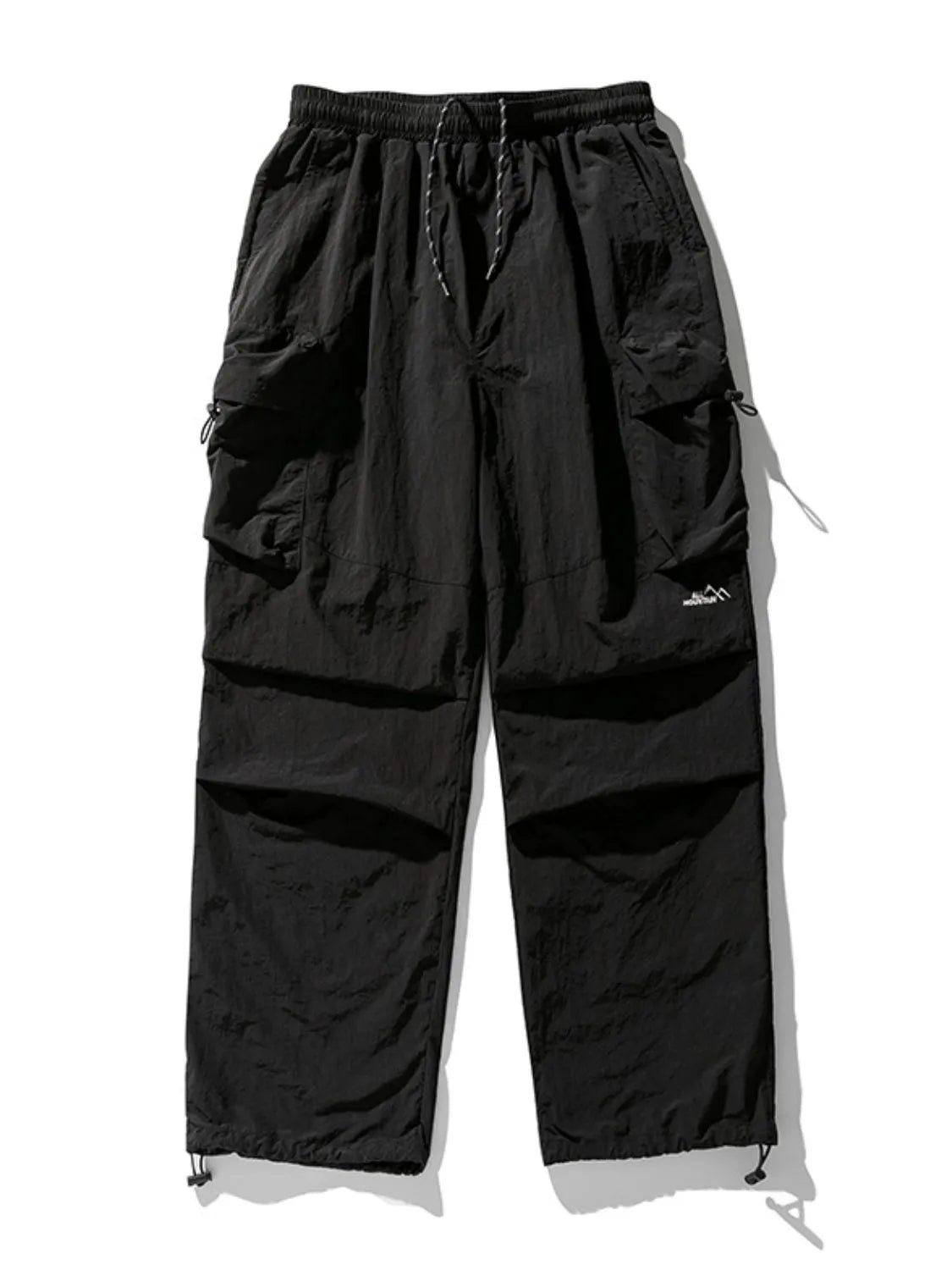Black oversized utility cargo pants with multiple pockets and drawstring ankles.