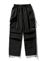 Black oversized utility cargo pants with multiple pockets and drawstring ankles.