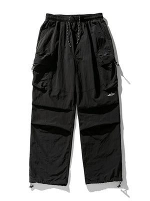 Black oversized utility cargo pants with multiple pockets and drawstring ankles.