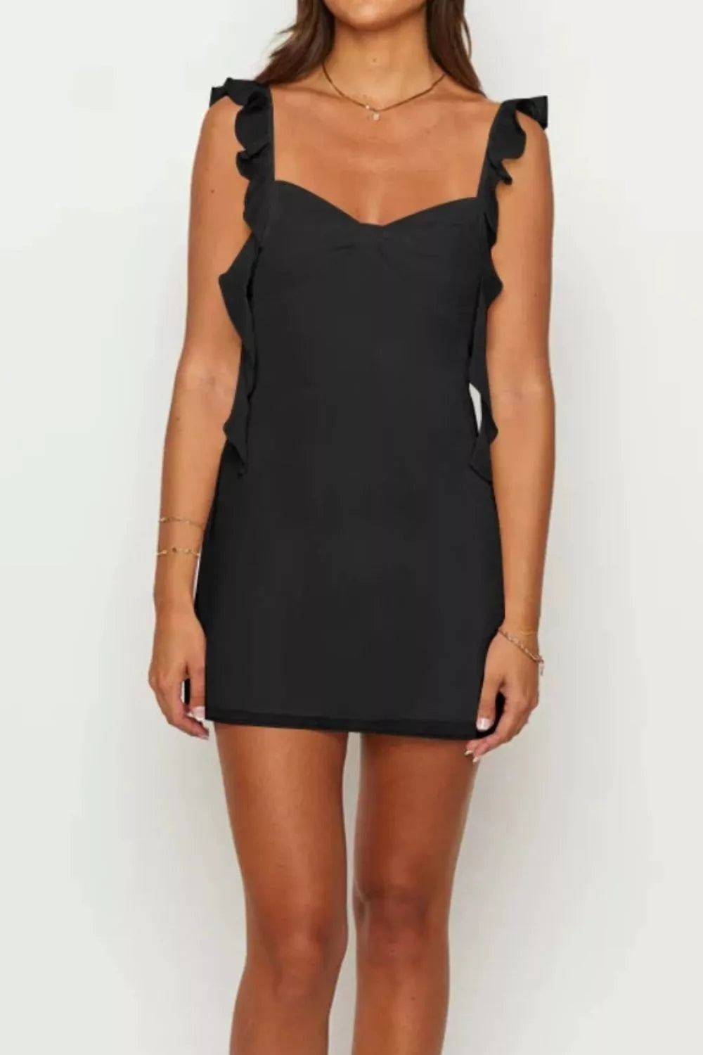 Black mini dress with sweetheart neckline and ruffled shoulder straps.