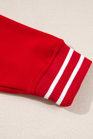 Deep red cotton sweatshirt sleeve detail with white striped ribbed cuff