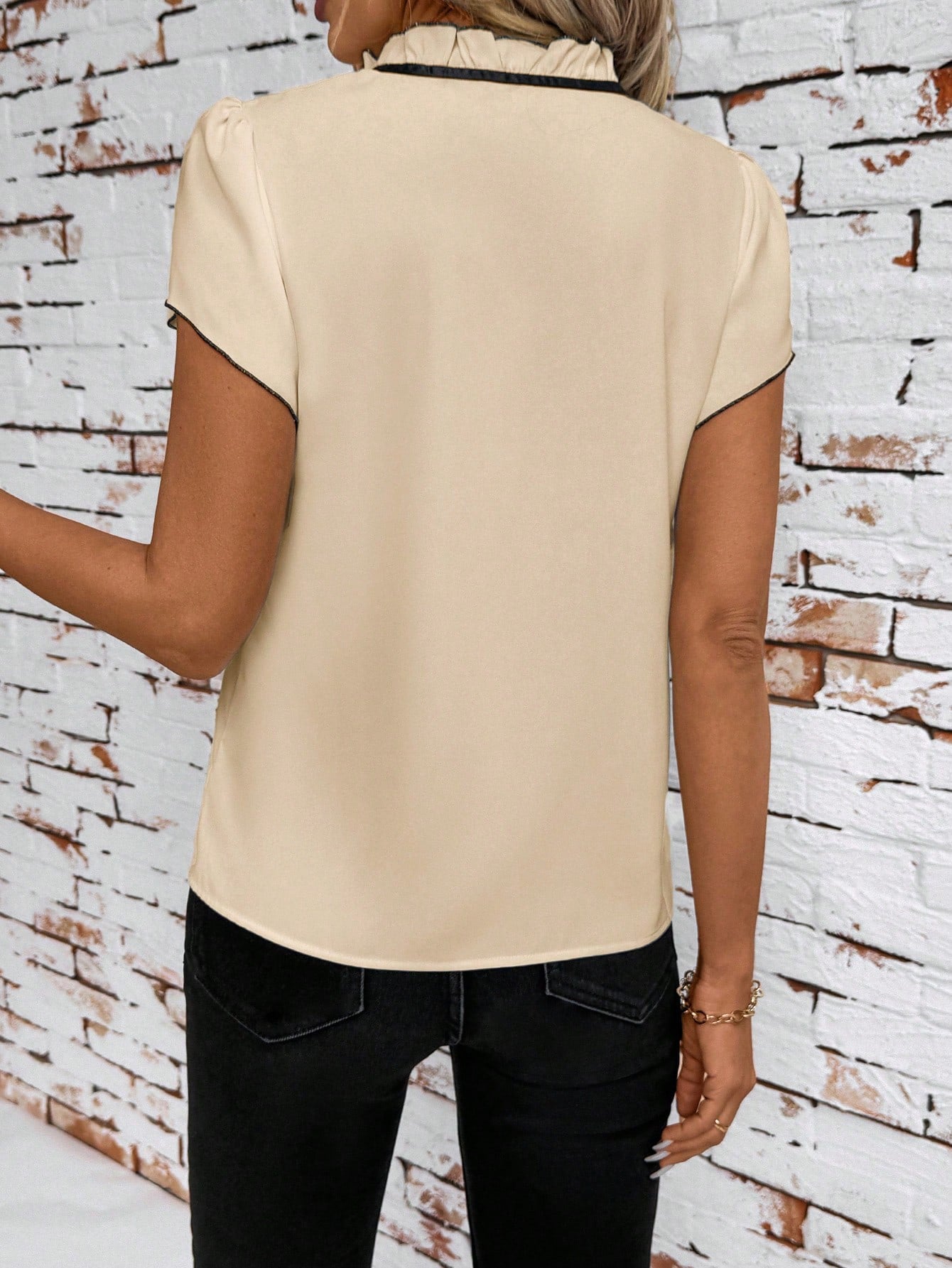 Apricot maternity blouse with frilled tie-neck and short sleeves.