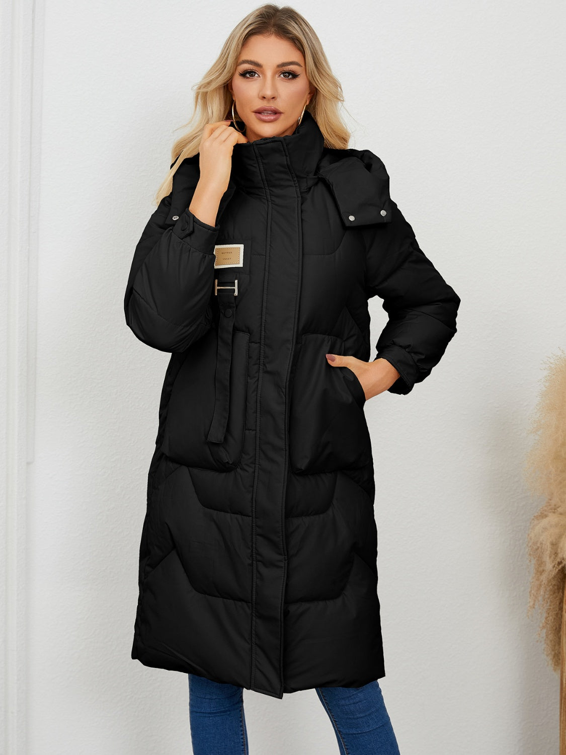 Black quilted puffer parka with buckle detail and hood