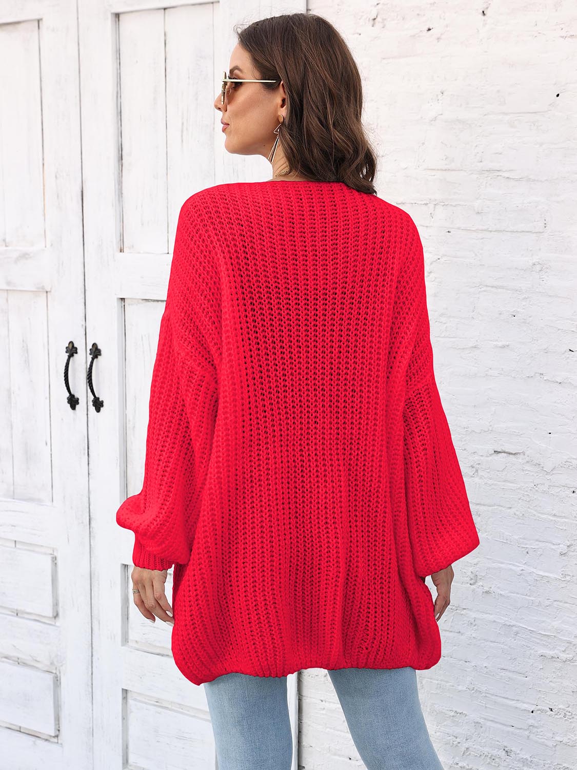 Red open knit cardigan with balloon sleeves and a relaxed fit.