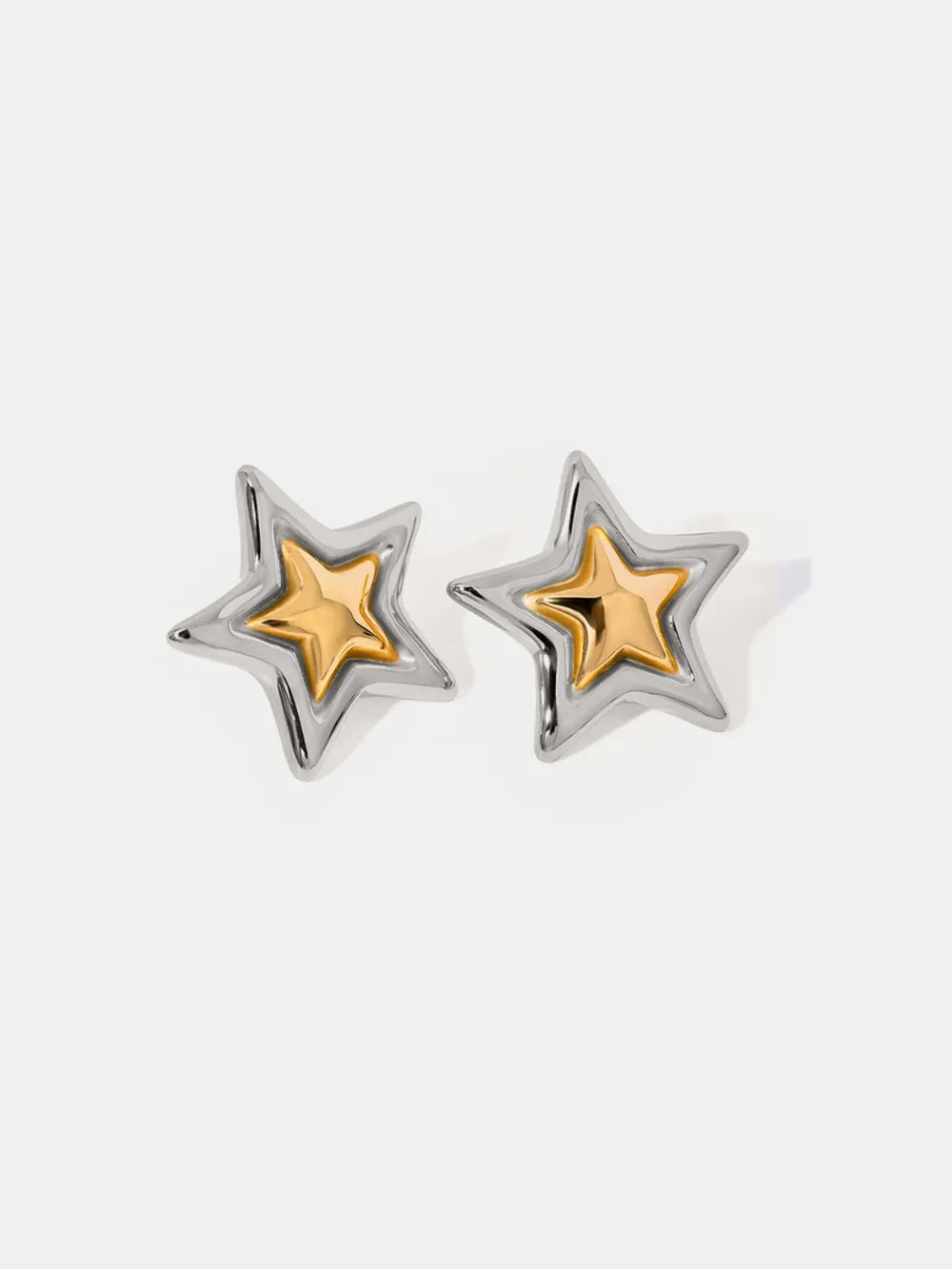 Sculpted starburst stud earrings in silver and gold with a celestial design.