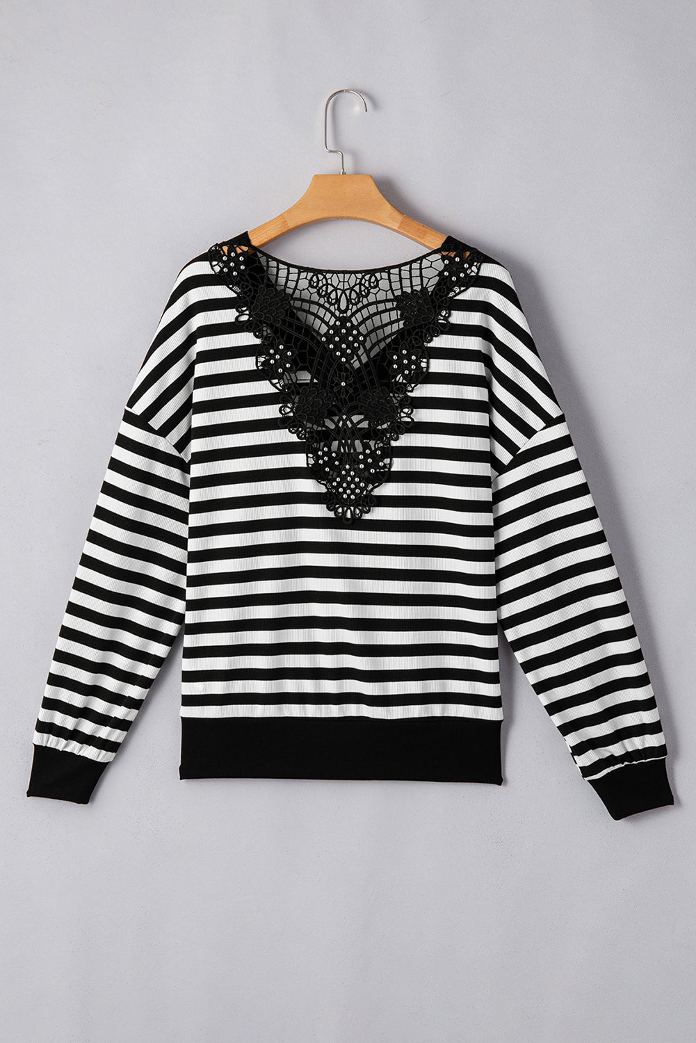 Black and white striped blouse with black lace detail on the back.
