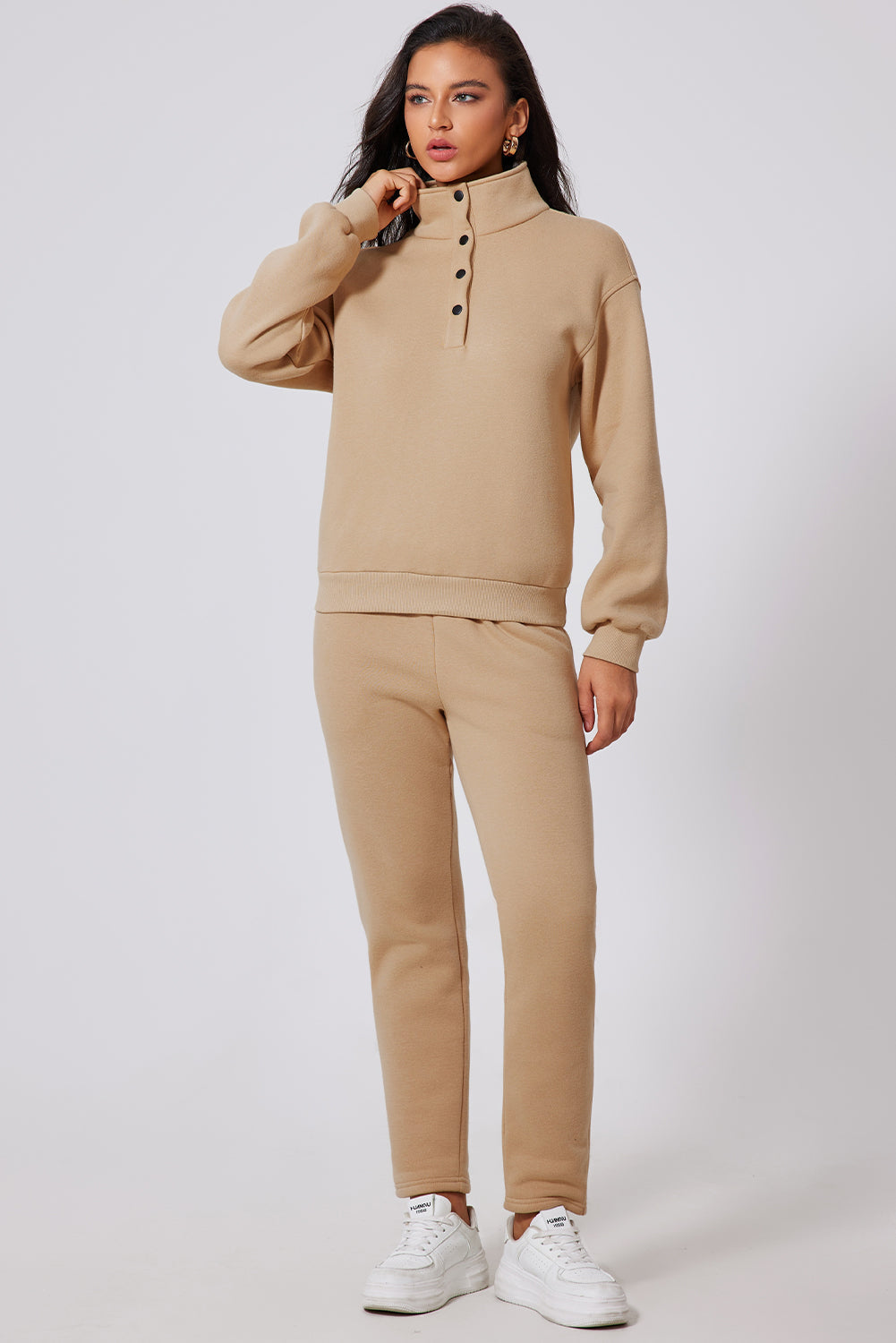 Button-neck lounge set in Dust Storm beige with black buttons, crewneck sweatshirt and matching pants.
