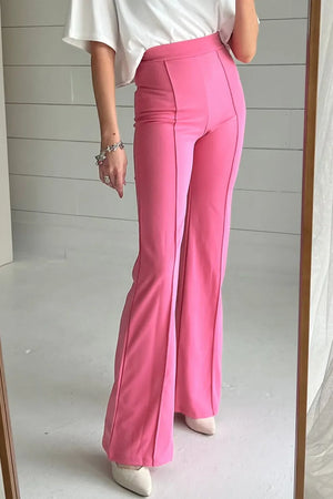 Pink seamed flare leg trousers with a high waist and subtle flare.