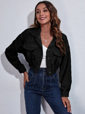 Black corduroy cropped utility jacket with buttoned chest pockets and elastic hem