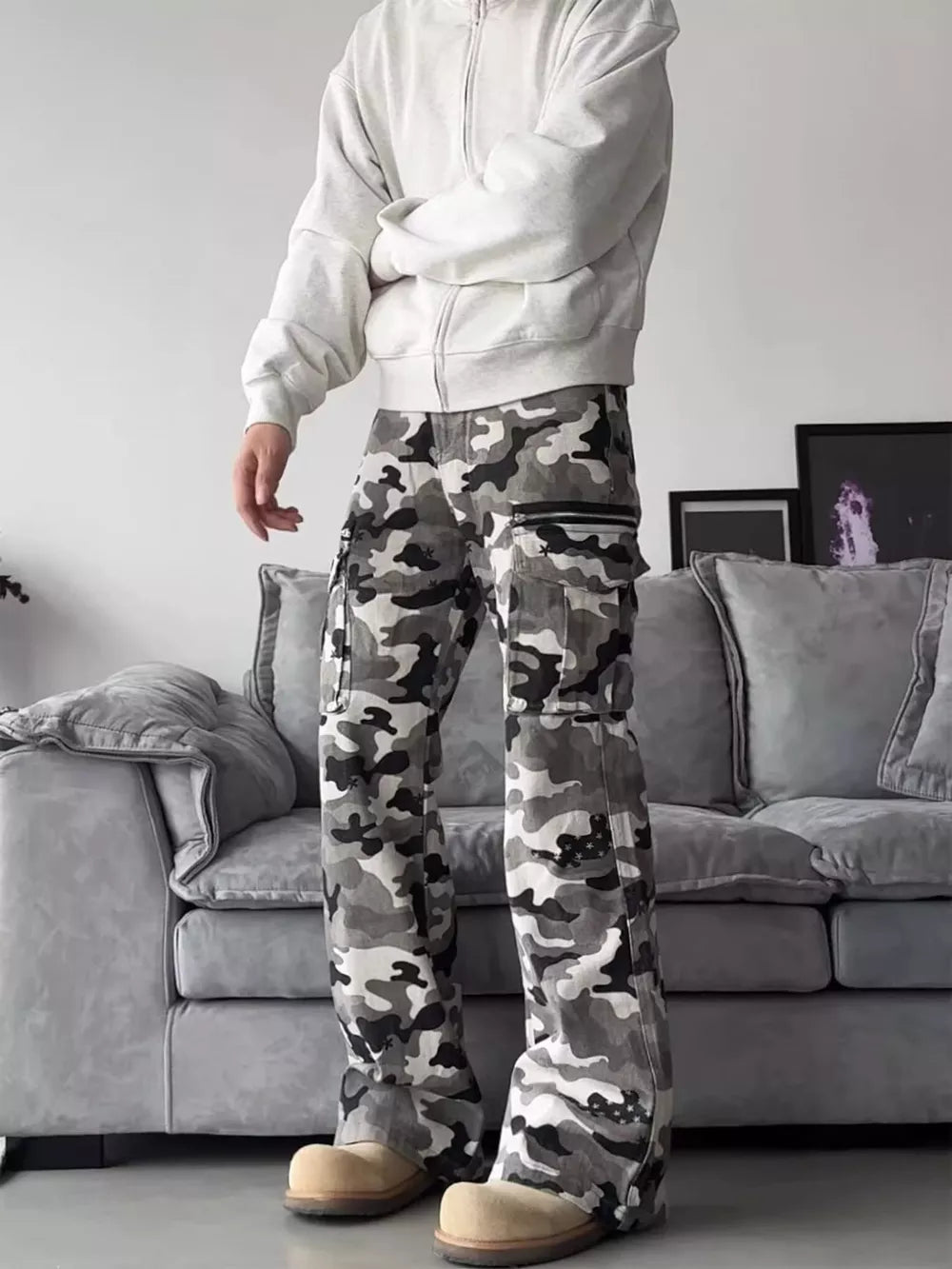 Camouflage utility wide-leg sweatpants with cargo pockets and zipper details.