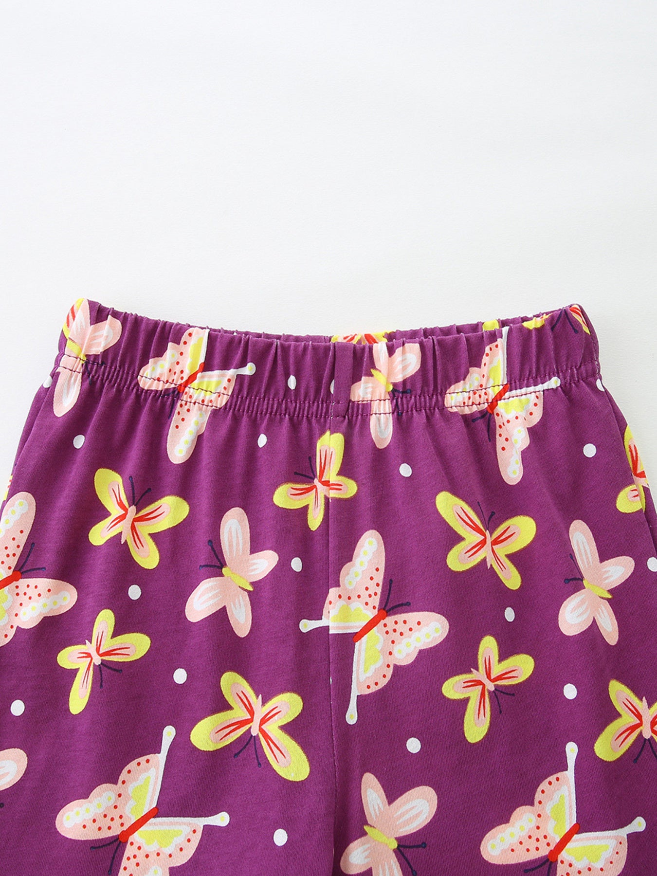 Purple cotton toddler girls' undershirt with allover butterfly print and ruffled sleeves.