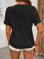 Black eyelet henley blouse with short sleeves and a relaxed fit.