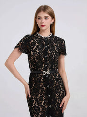 Black lace mermaid dress with pearl collar and jeweled bow belt