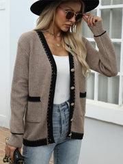 Taupe knit cardigan with black contrast trim and gold buttons, V-neck, long sleeves, pockets.