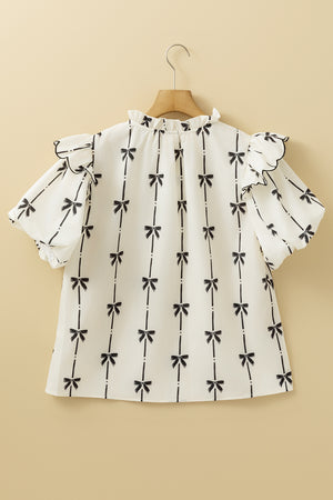 Ivory blouse with black bow print, ruffled neckline and short sleeves.