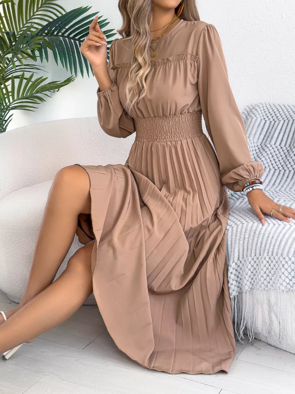 Khaki ruffled smocked waist midi dress with pleated skirt and long sleeves.