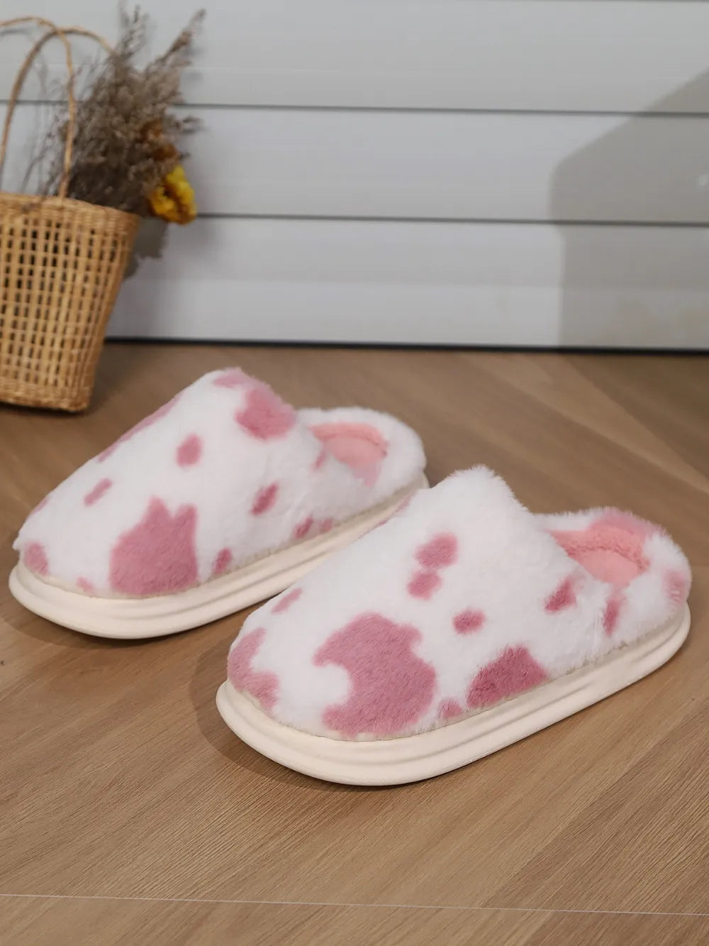 Blush pink cow print faux fur house slides with soft lining and platform sole.