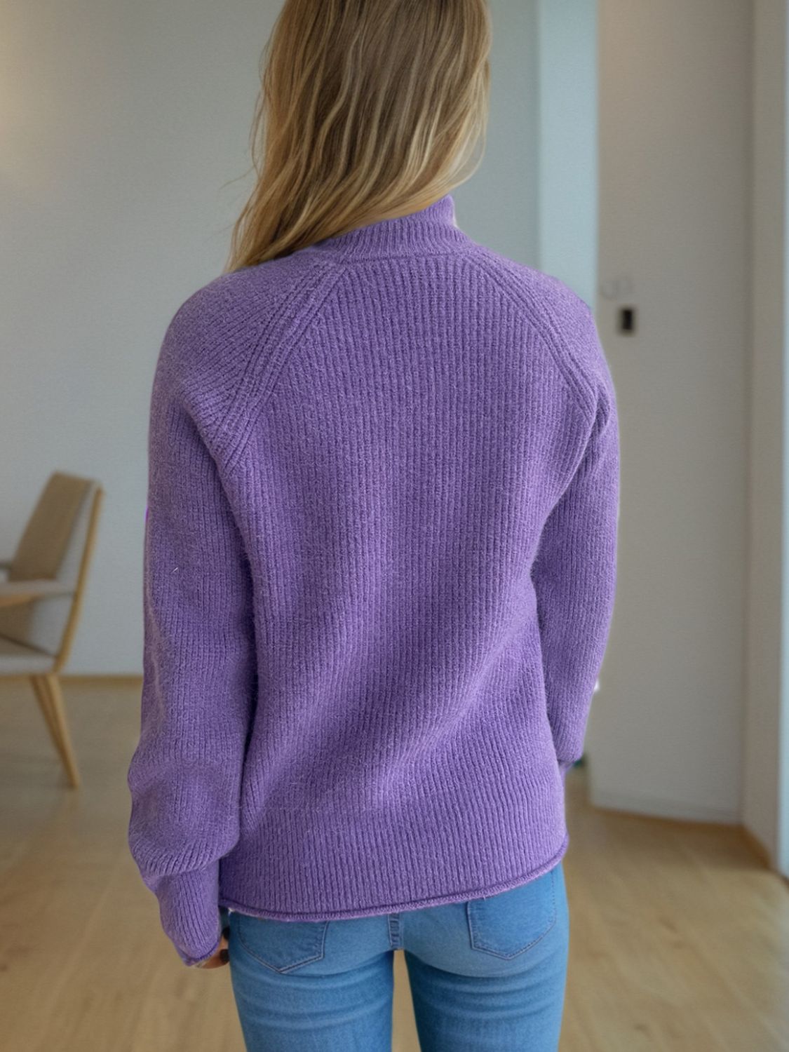 Lavender ribbed turtleneck sweater with raglan sleeves.