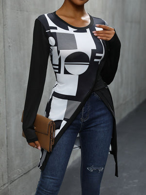 Black asymmetric tunic with geometric print, long sleeves, and a draped hem.