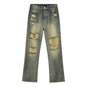 Distressed baggy jeans in medium wash cotton with shredded knees and raw hem.