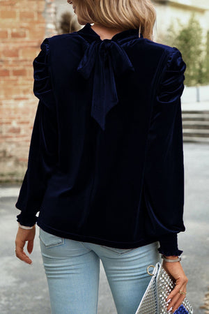 Navy velvet blouse with puff sleeves and back bow detail