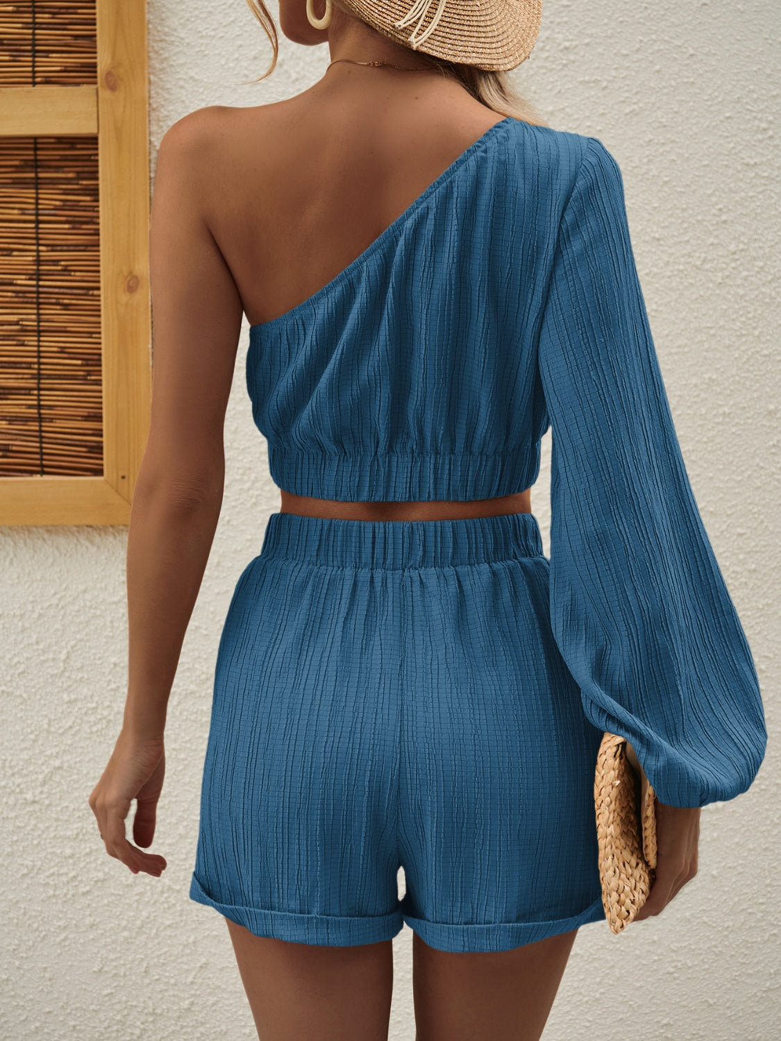 Textured one-shoulder crop top and cuffed shorts set in Royal Blue.
