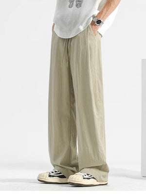 Beige wide-leg sweatpants with drawstring waist and pockets.
