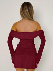 Ruched bodice off-shoulder top in rust with long sleeves and ruffled neckline.