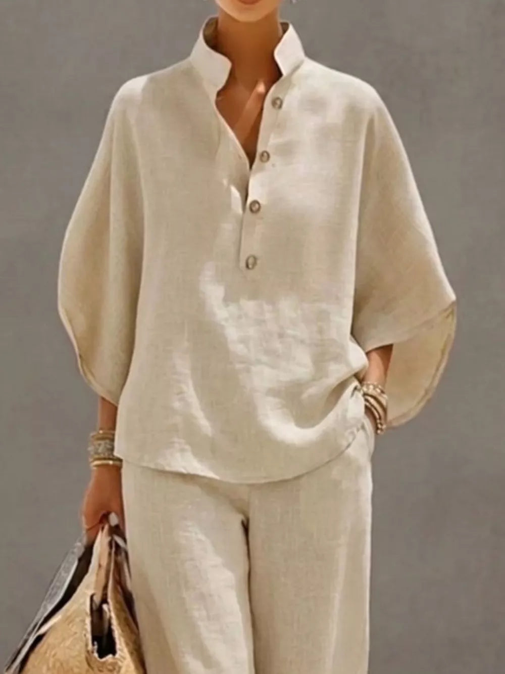 Chic buttoned loungewear set in apricot, featuring a stand collar and wide sleeves.