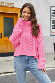 Cropped cable knit turtleneck sweater in hot pink acrylic with a high neck.