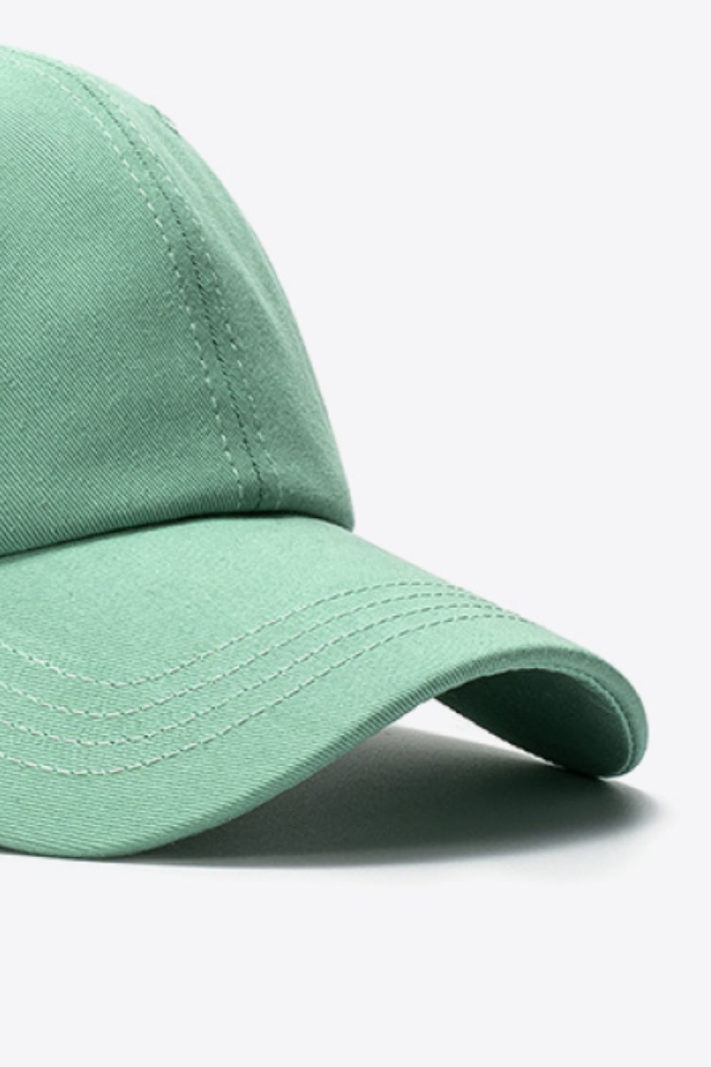 Green cotton baseball cap with white stitching detail