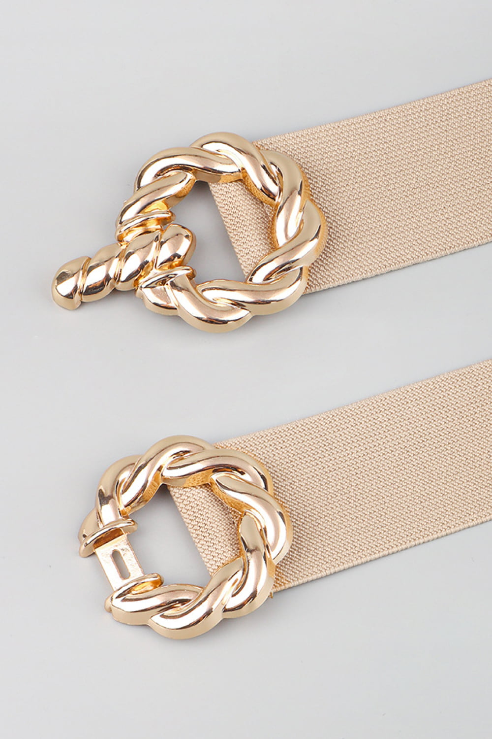 Braided knot stretch belt in tan with gold alloy buckle detail.
