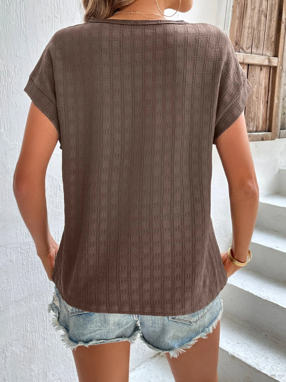 Woven texture cap-sleeve top in tan with a relaxed fit.