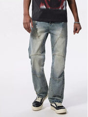 Men's light wash wide-leg jeans with moto-inspired paneling and ribbed knee details.