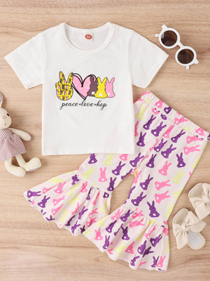 Baby girl's white tee with bunny graphic and pink bell-bottom pants with bunny print.