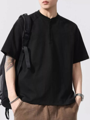 Black buttoned henley t-shirt for men with short sleeves and a band collar.